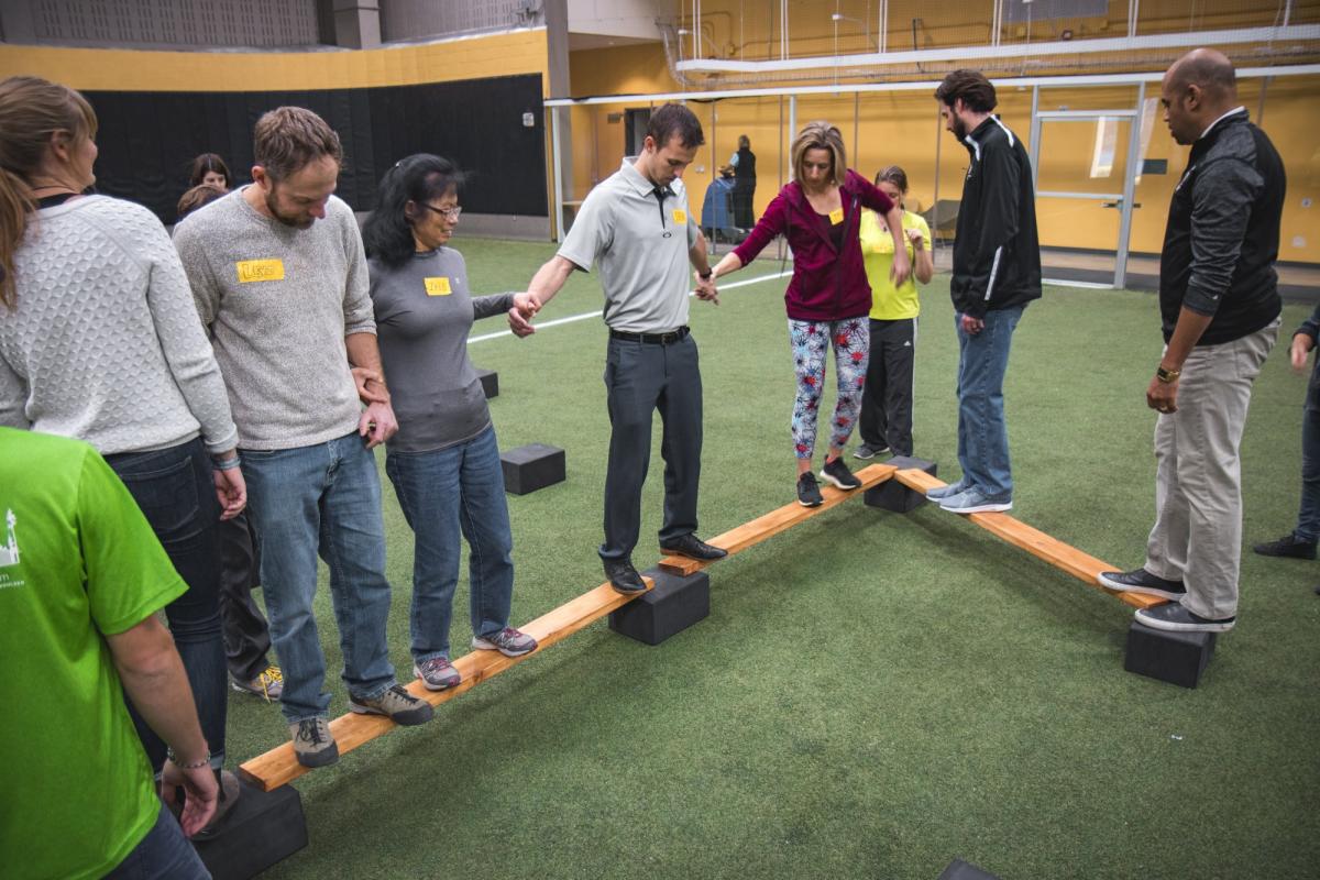 students standing on logs