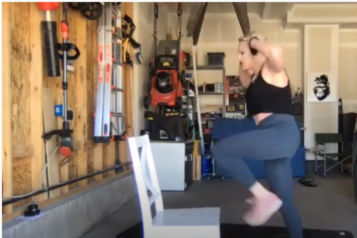 beth stepping onto a chair for her guided workout