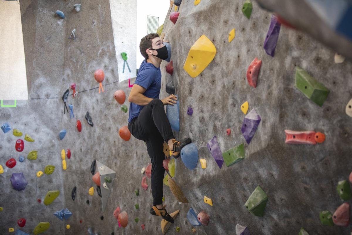 student climbing the rock wall