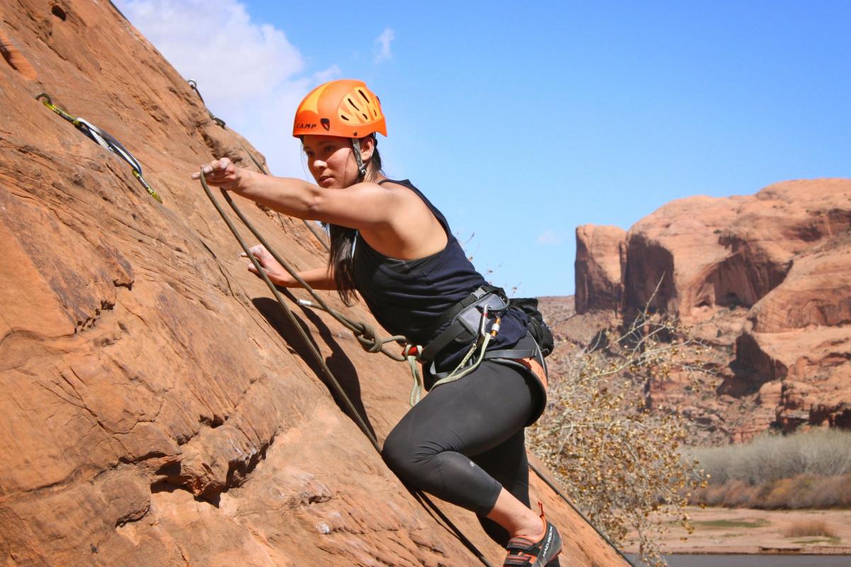 woman climbing a rock