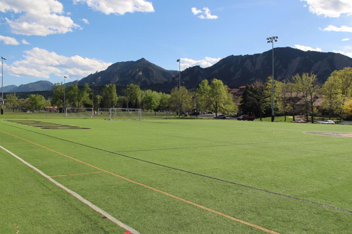 green grassy field on the cu campus