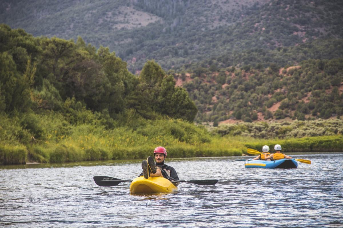 student kayaking on the river