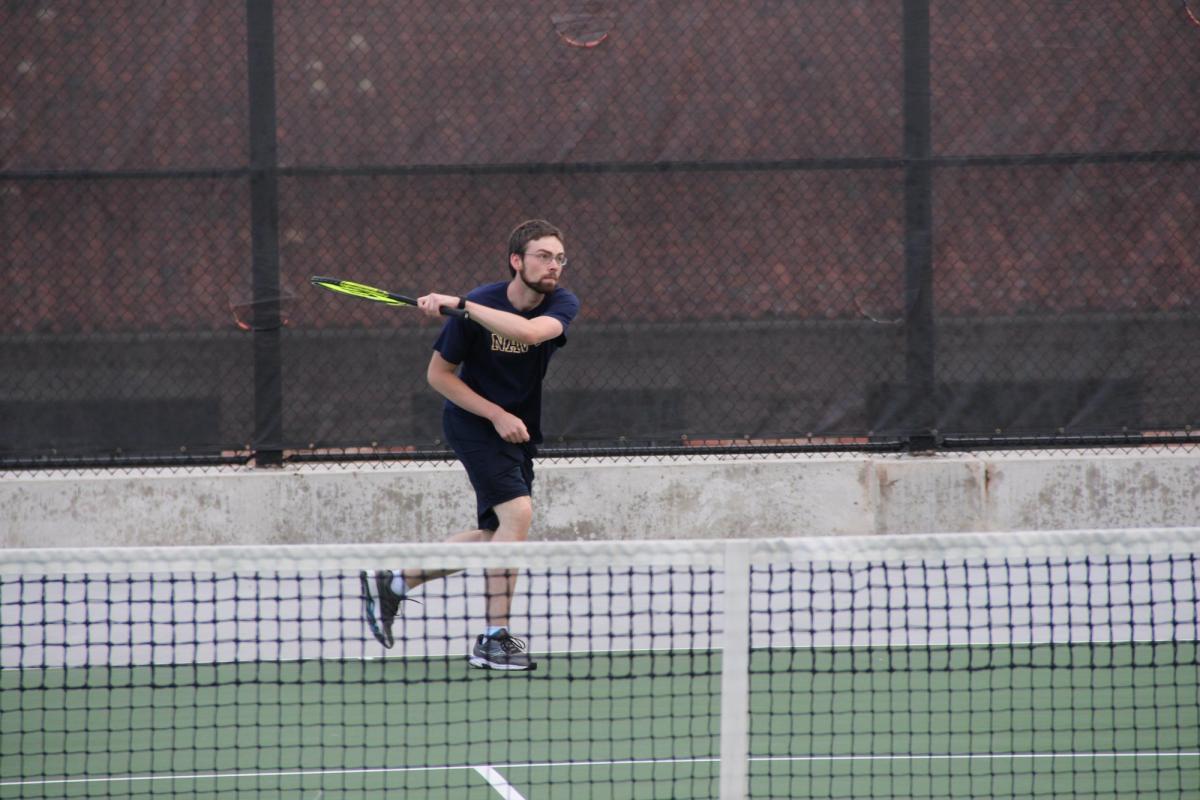 student playing tennis on the roof