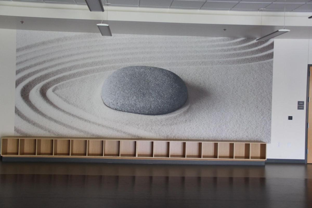 mind body studio with a painting of a rock on the wall