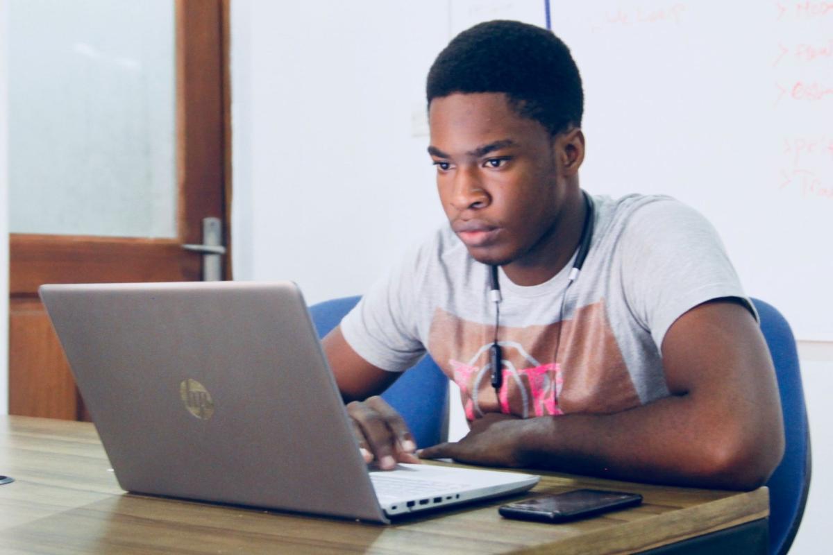 man typing on his laptop