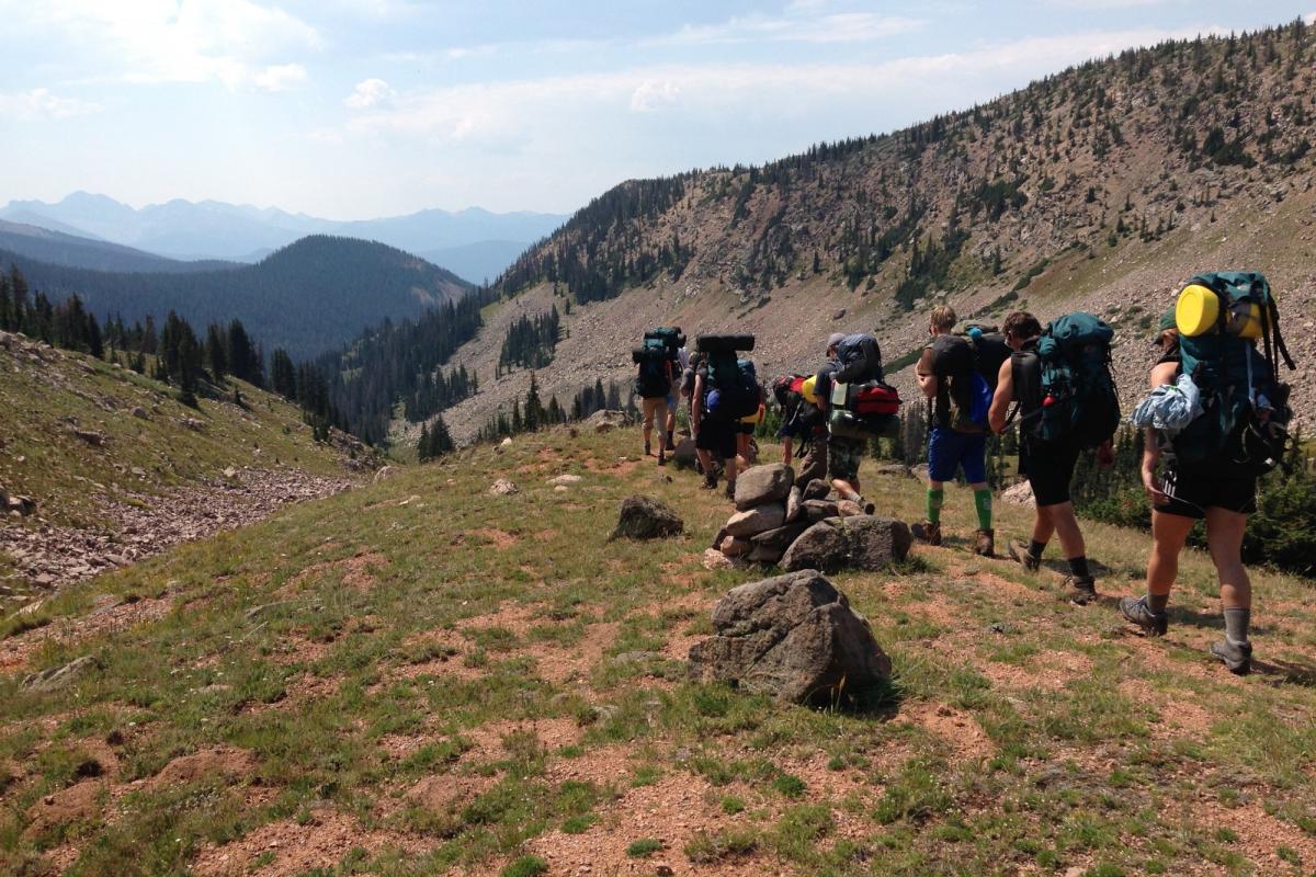 a long line of people with backpacks on