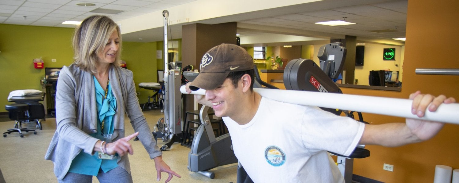 Student working with physical therapist