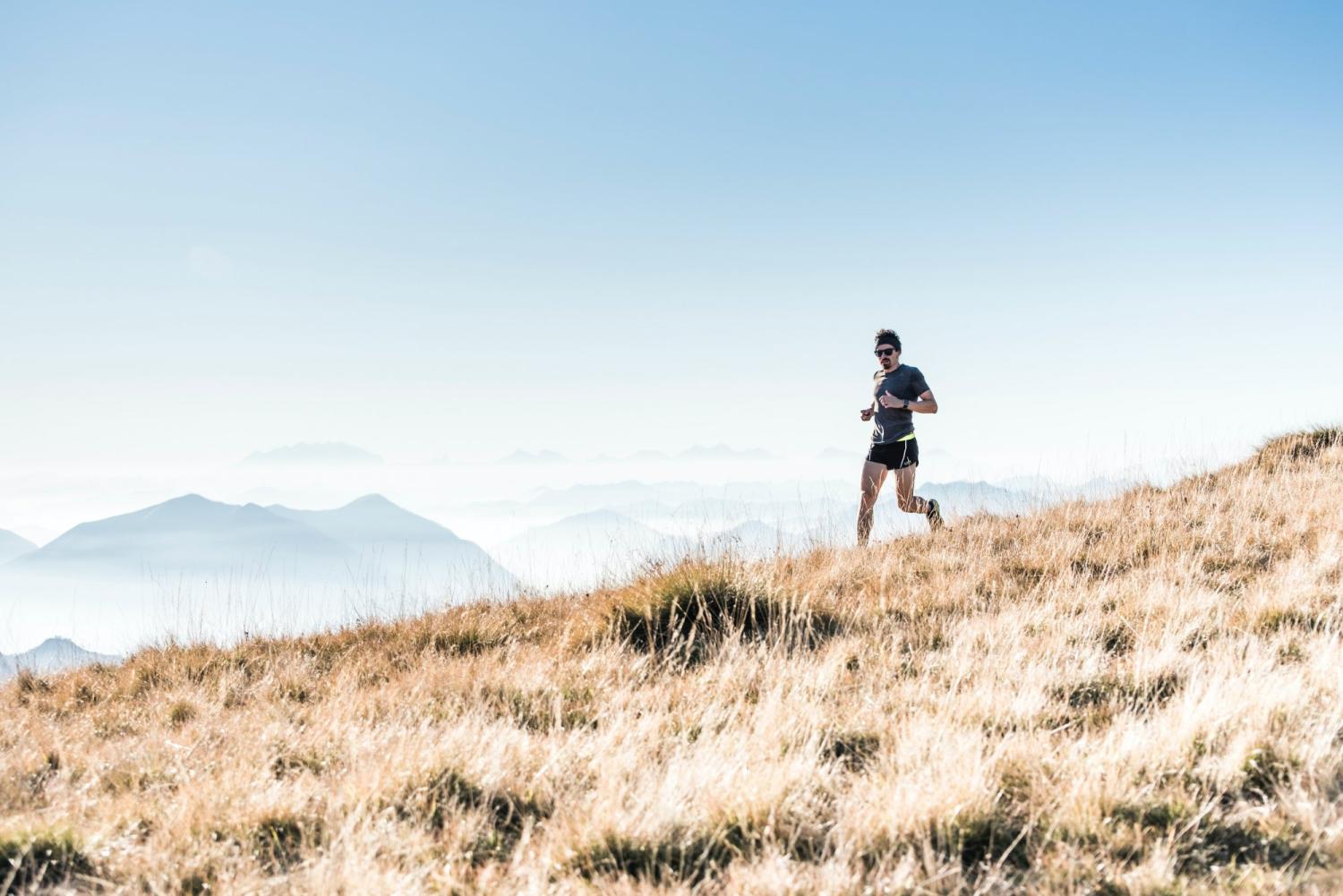man running on edge near mountain