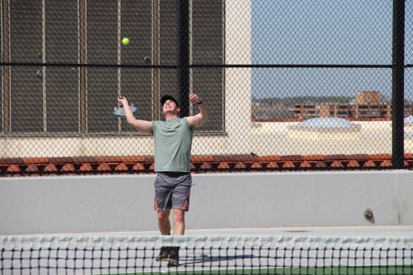 student playing tennis