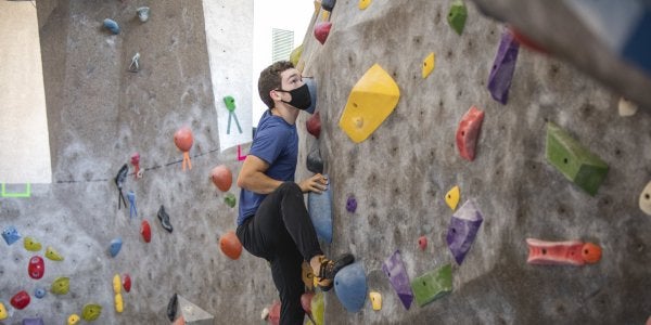 student climbing the rock wall