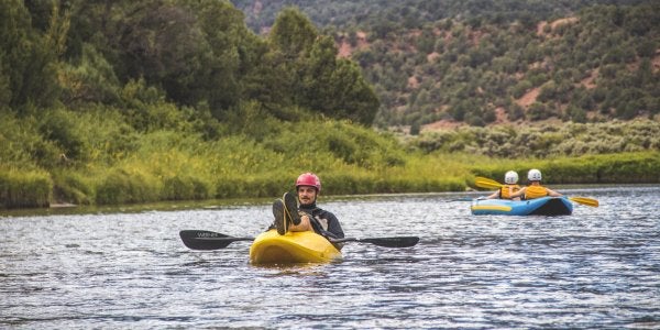 student kayaking on the river