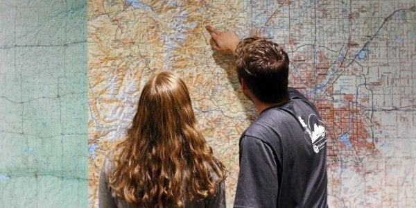 student pointing at a map