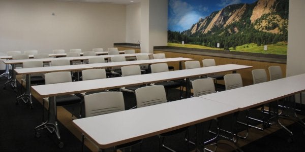 studio four meeting room with two long tables and a dozen chairs