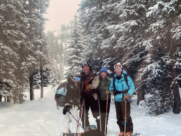 happy family posing together in the snow