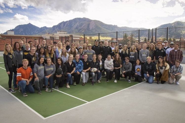 Group photo of sport club members on roof of Rec Center.