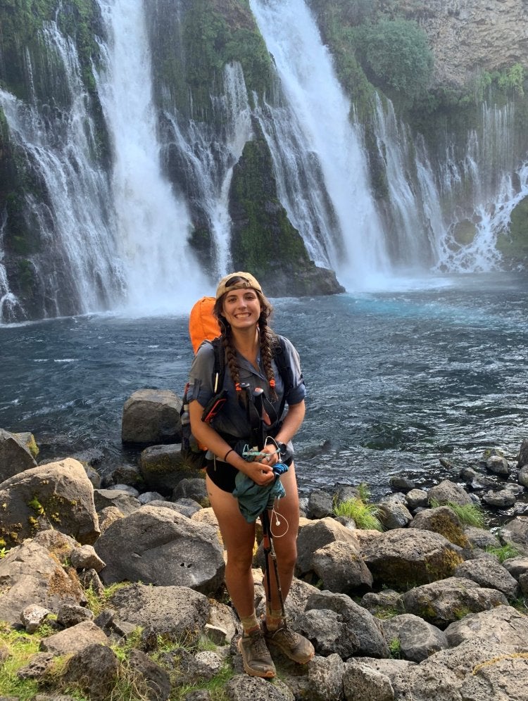 woman standing in front of a waterfall