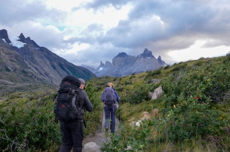 two people hiking through a valley in Patagonia