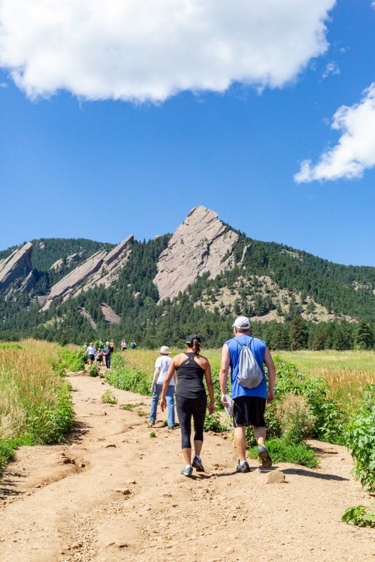 people hiking up a long trail