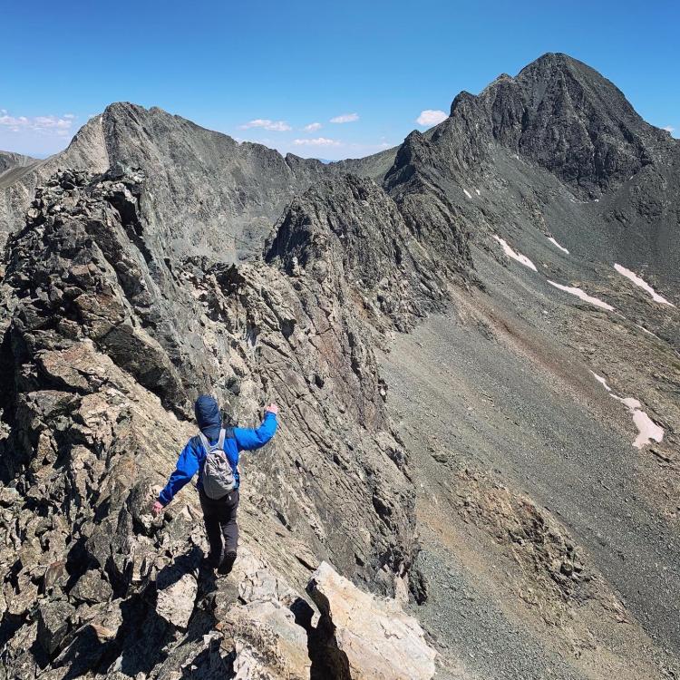 student on a mountain peak