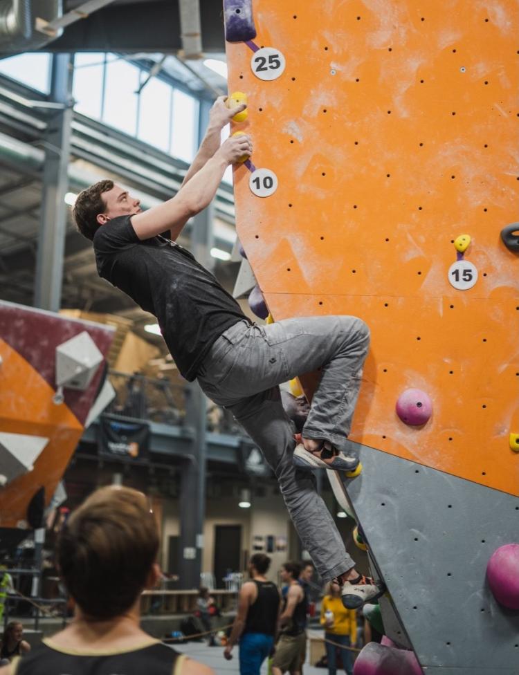 a man climbing up a rock wall