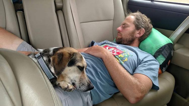 levi sleeping with a dog in his lap