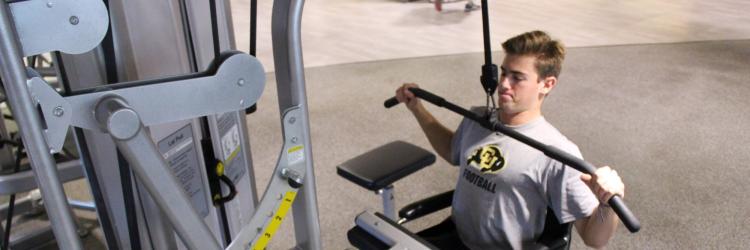 Student using adaptive equipment at rec center