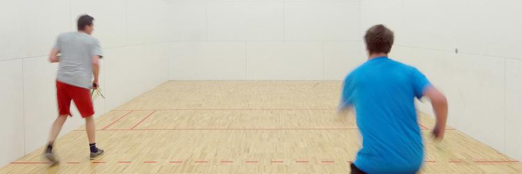 two students playing racquetball