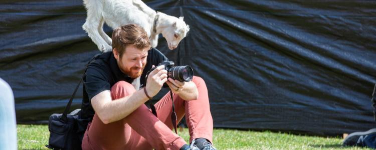Photographer taking photos during goat yoga