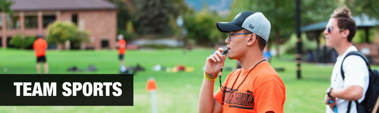 Sports official blowing a whistle
