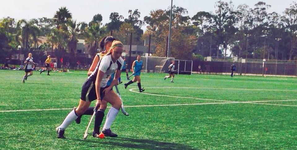women playing field hockey