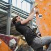 a man climbing up a rock wall