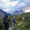 two people hiking through a valley in Patagonia