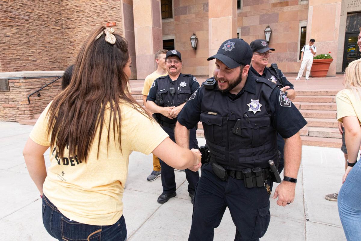 Photo of CUPD officers shaking hands with students.