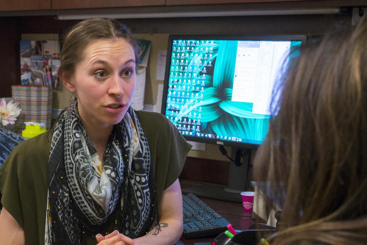 A financial aid counselor assisting a student.