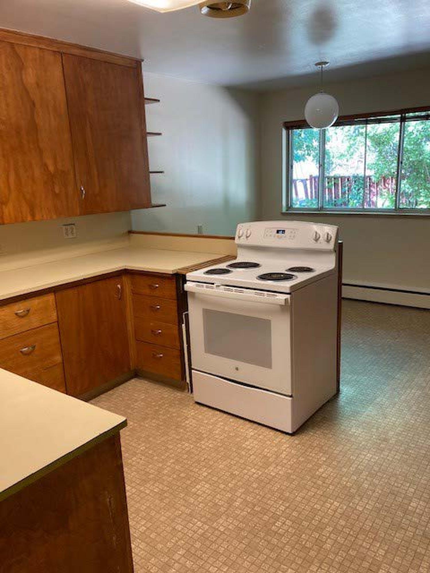 Shot of the kitchen with oven/stove and cabinets