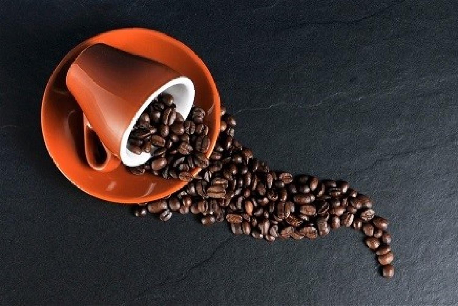 Image of coffee cup spilling coffee beans