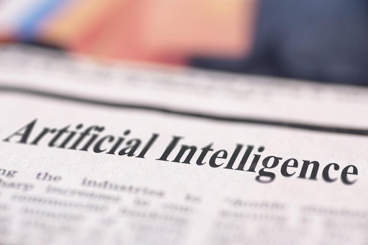 A photo of a newspaper with a headline that reads artificial intelligence.