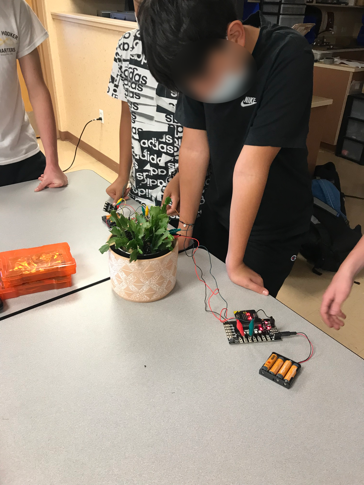 Middle School students working on a plant sensor.