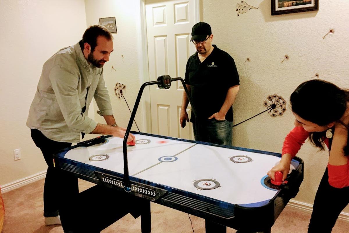 People playing air hockey