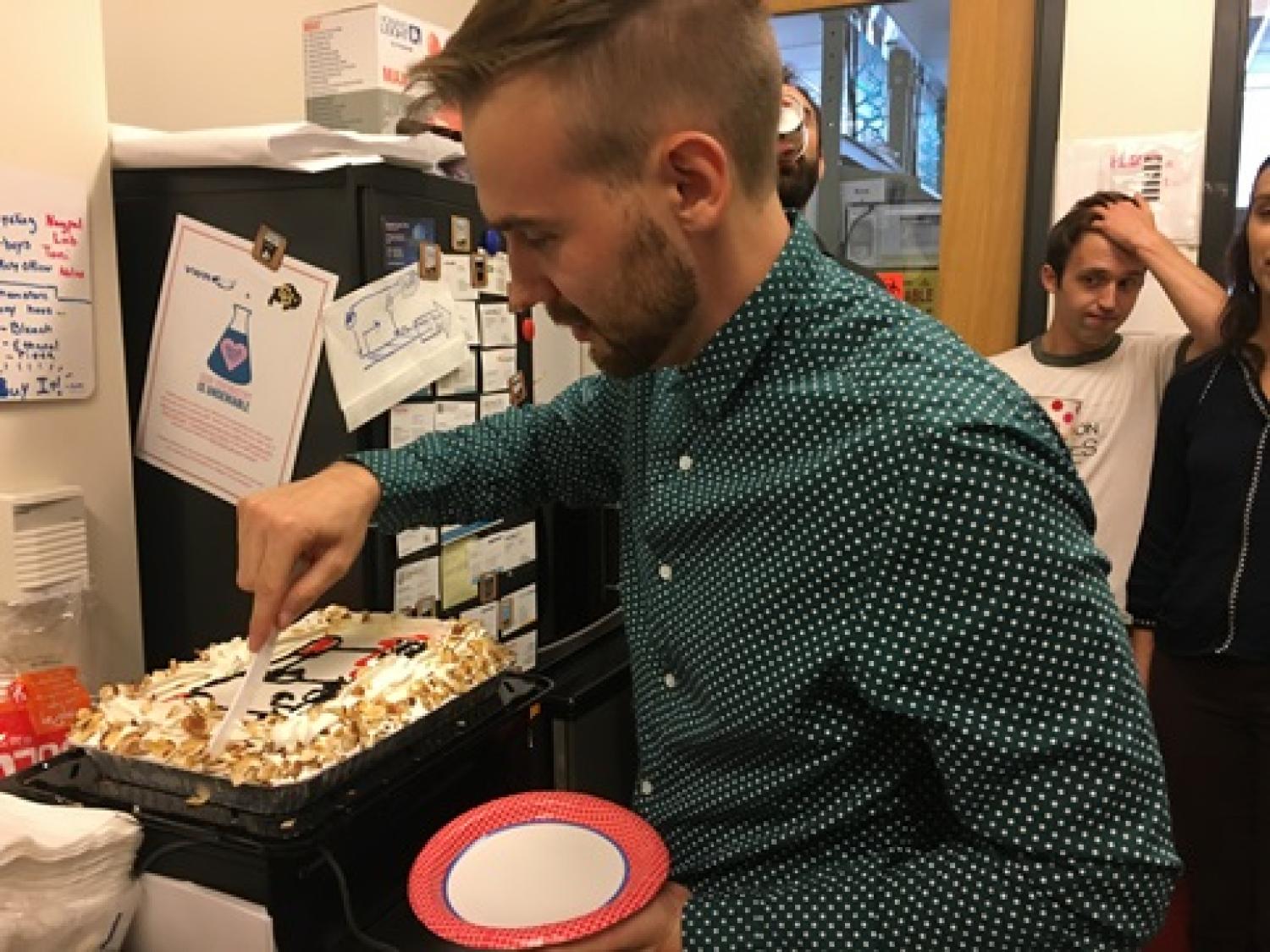 Aug 2018: Toni celebrates by cutting the original Transcriptional Interference (TI) inspired cake! You can see the blueprint (on the paper towel) behind.