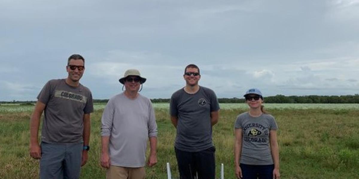 The TRACER Team stands behind a RAAVEN