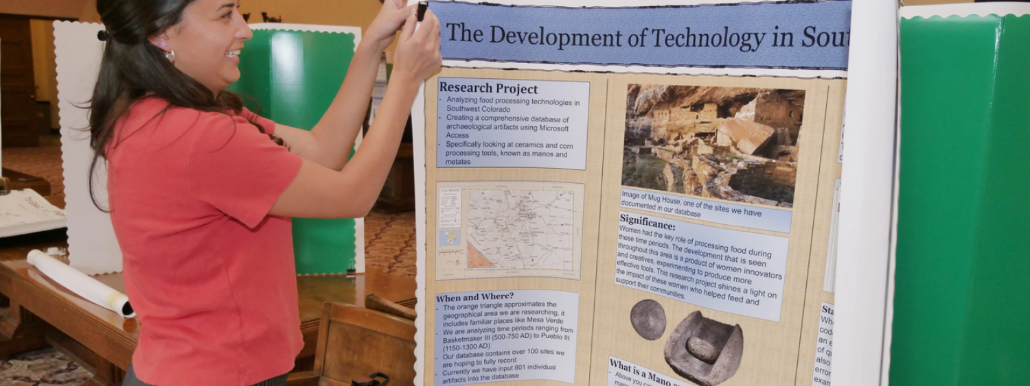 student setting up poster about research