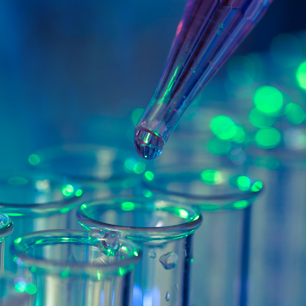 Pipette adding fluid to one of several test tubes