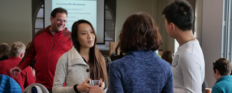 Participants talking at the RIO Understanding Broader Impacts workshop.