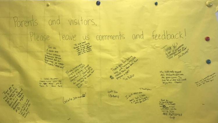 Large sheet of paper with written comments from different people.