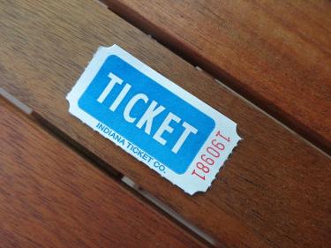 Single admission ticket stub on a wood table