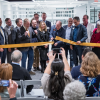 Platform guests and dignitaries watch Gov. Jared Polis cut a ribbon to celebrate the opening of the Quantum Incubator site 