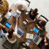 Entrepreneurs meeting at a table with laptops open