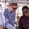 Scott Diddams and graduate students manipulating an optical frequency comb in the Engineering Center lab at CU Boulder