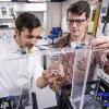 two students working on robot prototype in lab
